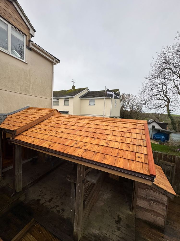 Finished cedar shingle roof extension over a patio