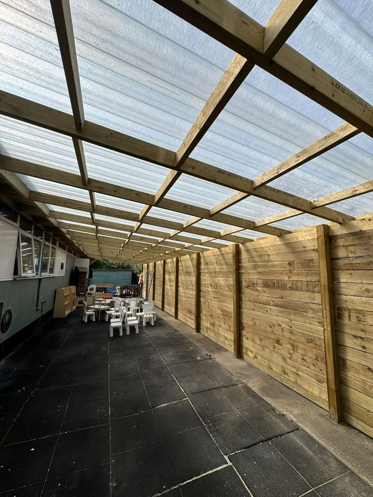 Timber-framed covered outdoor area with polycarbonate roof